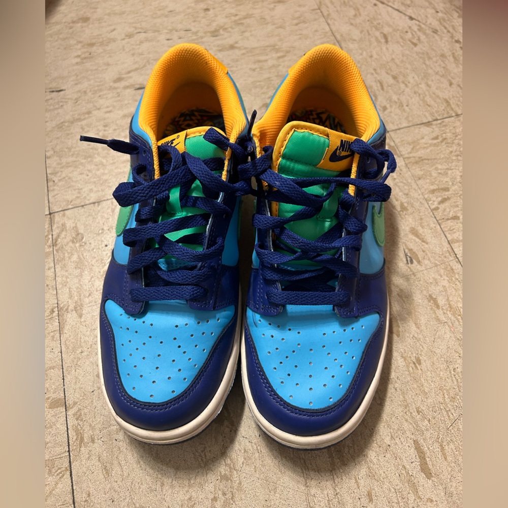 Green, blue and yellow nike shoes